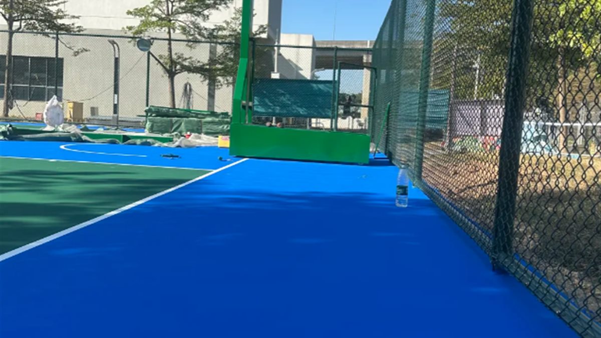 Blue acrylic perimeter of outdoor sports court